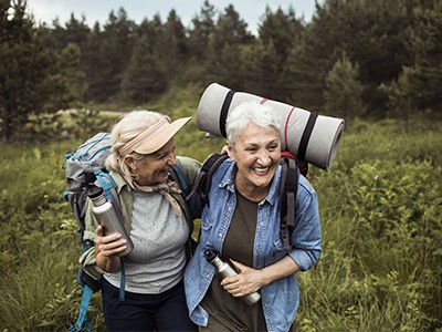 Close up of two senior female friends hiking together